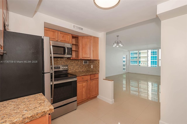 kitchen with hanging light fixtures, appliances with stainless steel finishes, decorative backsplash, light tile patterned floors, and a chandelier