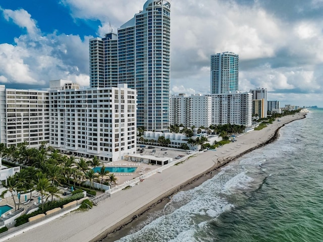 exterior space featuring a water view and a beach view