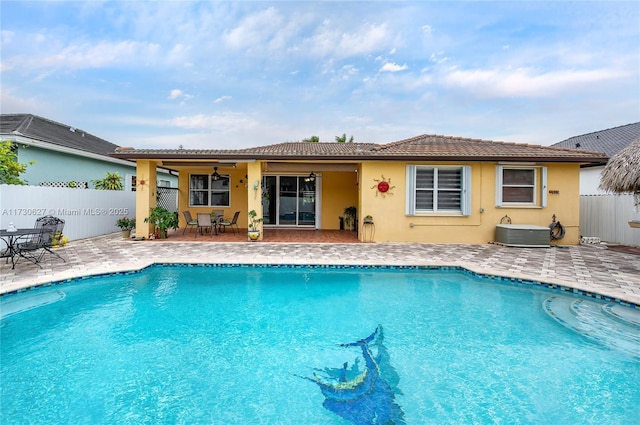 view of swimming pool with a patio area, central AC unit, and ceiling fan