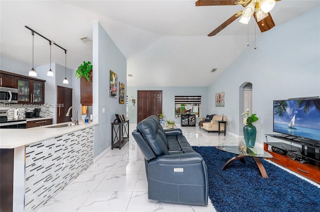 living room featuring sink, vaulted ceiling, and ceiling fan