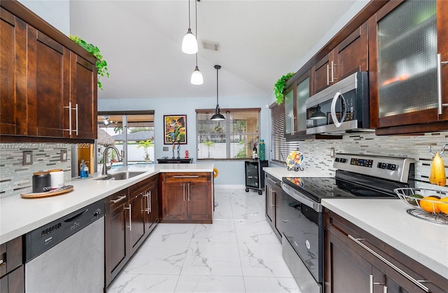 kitchen with decorative light fixtures, sink, backsplash, and appliances with stainless steel finishes