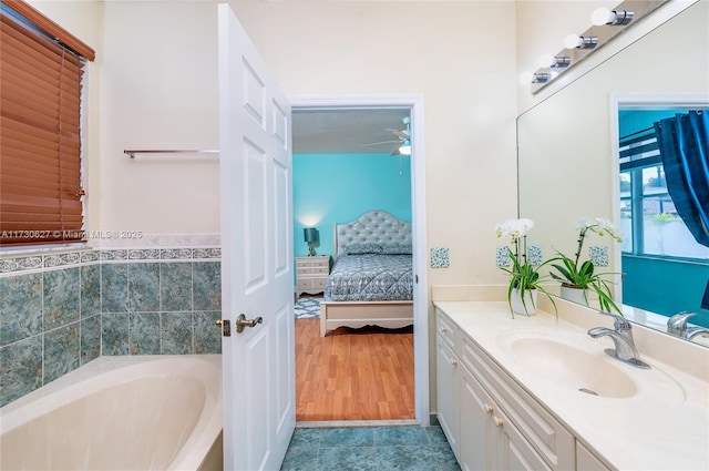 bathroom with a bath, tile patterned flooring, and vanity