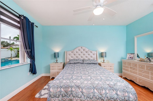 bedroom with ceiling fan and light hardwood / wood-style flooring