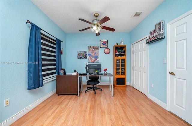 office space with light wood-type flooring and ceiling fan