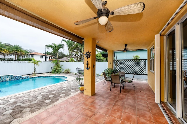 view of pool with a patio area and ceiling fan