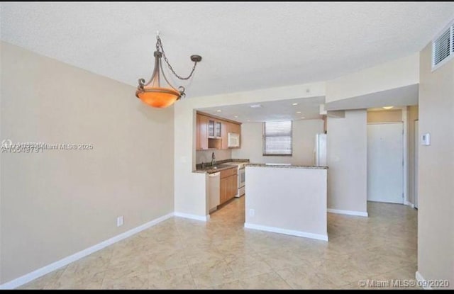 kitchen featuring sink, hanging light fixtures, and white appliances