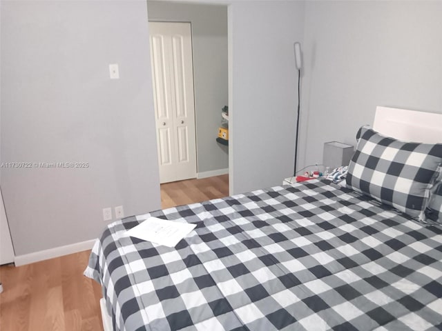 bedroom featuring light hardwood / wood-style floors and a closet