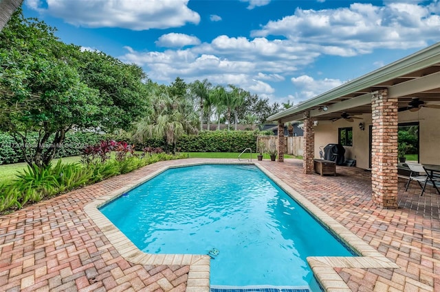 view of pool with a patio area and ceiling fan