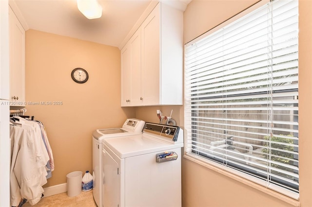 laundry area with cabinets, light tile patterned floors, and independent washer and dryer