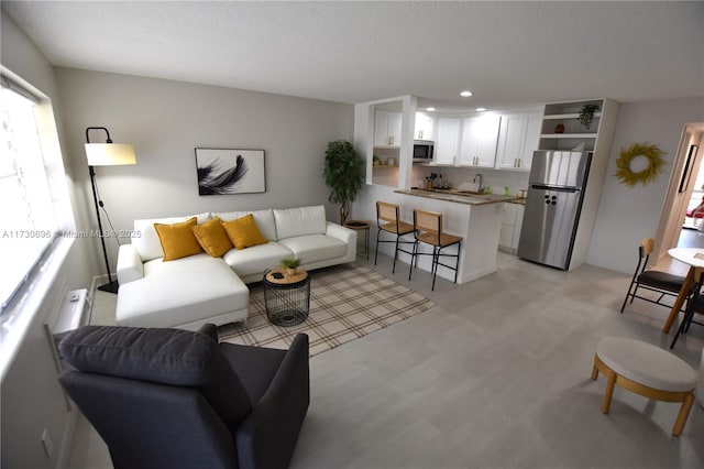 living room with sink and a textured ceiling