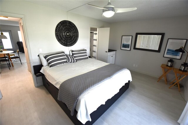 bedroom featuring ceiling fan and light wood-type flooring