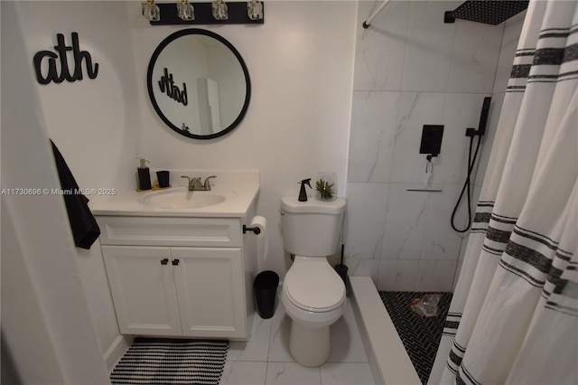 bathroom featuring vanity, curtained shower, and toilet