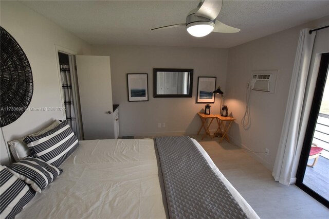 bedroom featuring a wall unit AC and ceiling fan