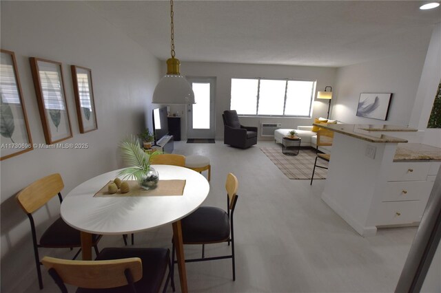 dining room featuring a wall mounted air conditioner