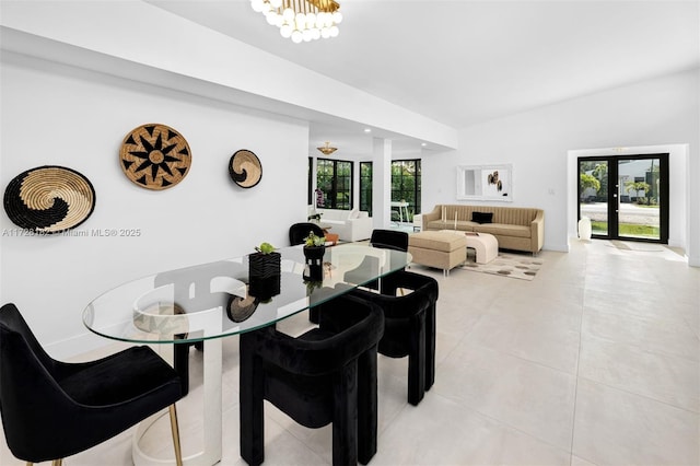 dining area with a healthy amount of sunlight, an inviting chandelier, and french doors