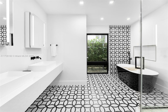 bathroom featuring sink and separate shower and tub