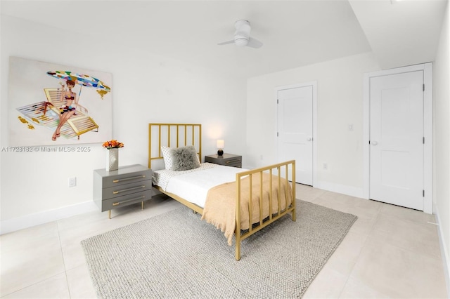 tiled bedroom featuring ceiling fan