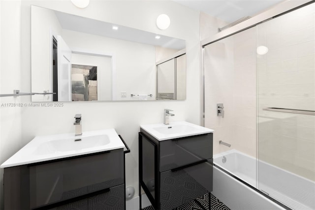 bathroom featuring shower / bath combination with glass door and vanity