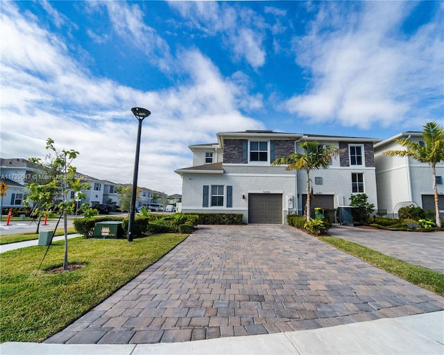 view of front of home with a front yard and a garage