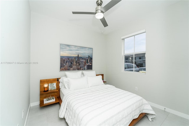 bedroom with ceiling fan and light tile patterned floors