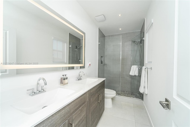 bathroom featuring tile patterned floors, toilet, vanity, and an enclosed shower