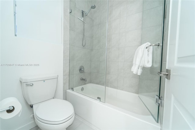 bathroom featuring toilet, tiled shower / bath, and tile patterned flooring