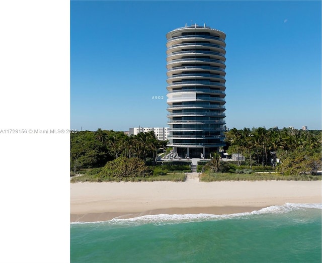 view of property with a view of the beach and a water view