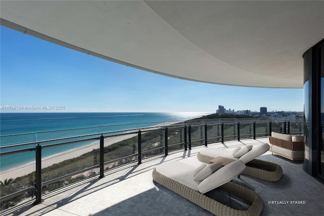 balcony with a water view and a beach view