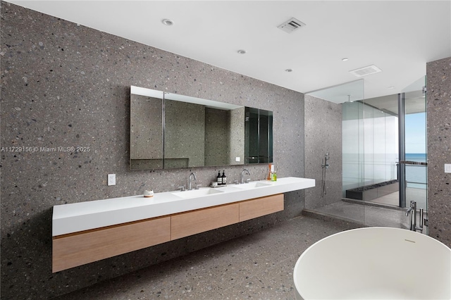 bathroom with vanity, independent shower and bath, and a water view