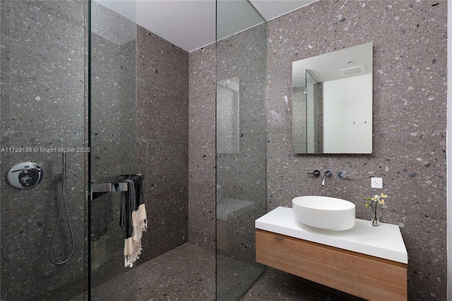 bathroom with vanity and tiled shower