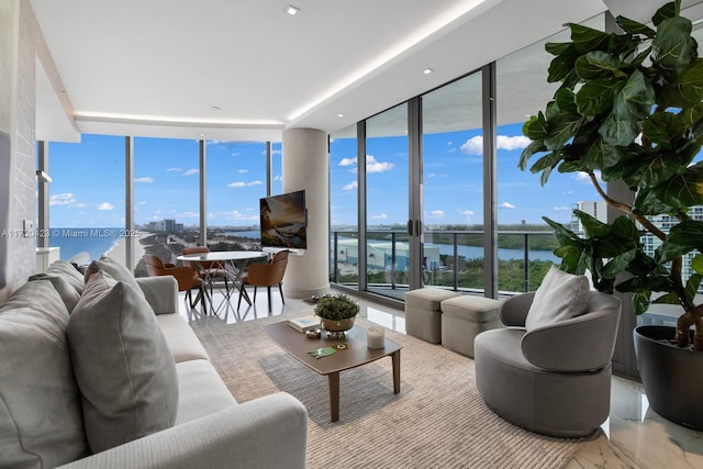 living room featuring a wealth of natural light and a wall of windows