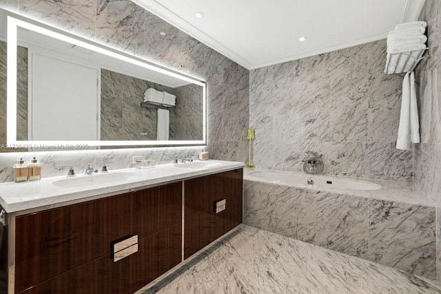 bathroom featuring a relaxing tiled tub, vanity, crown molding, and tile walls