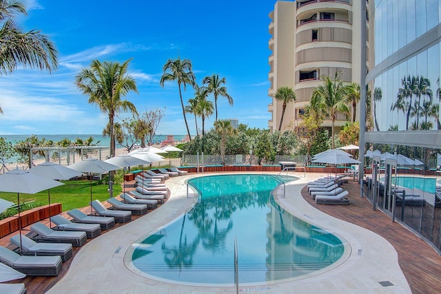 view of pool with a patio and a water view