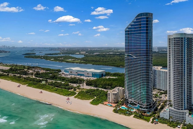 birds eye view of property featuring a water view and a view of the beach