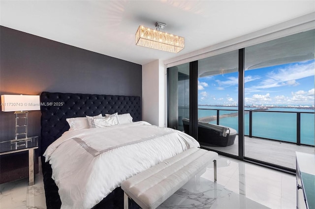 bedroom with a water view, expansive windows, and access to outside