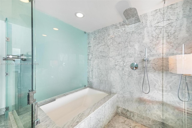 bathroom featuring shower with separate bathtub