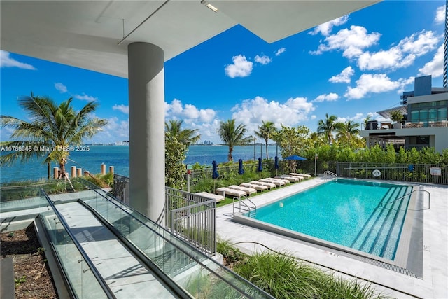 view of pool with a water view