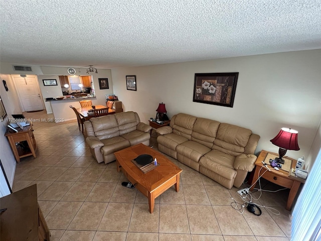3300 W Rolling Hills Cir Unit 102, Davie, FL 33328 - living room featuring light tile patterned floors and a textured ceiling
