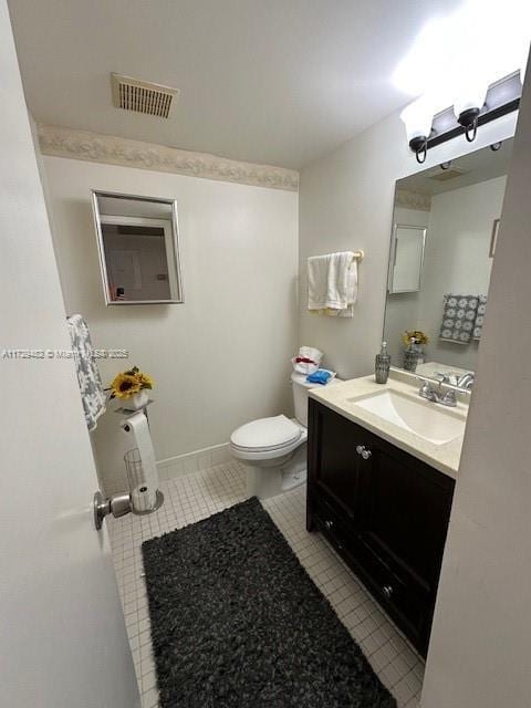 bathroom featuring vanity, toilet, and tile patterned floors