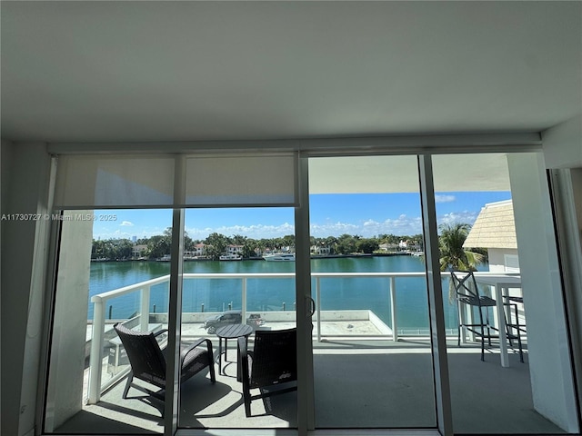 interior space with a water view and a healthy amount of sunlight