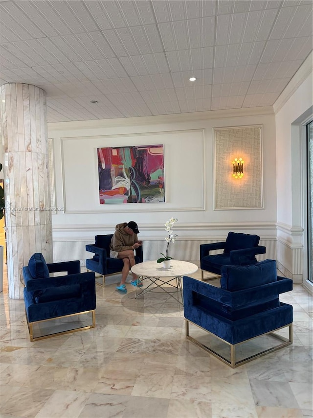 sitting room featuring crown molding