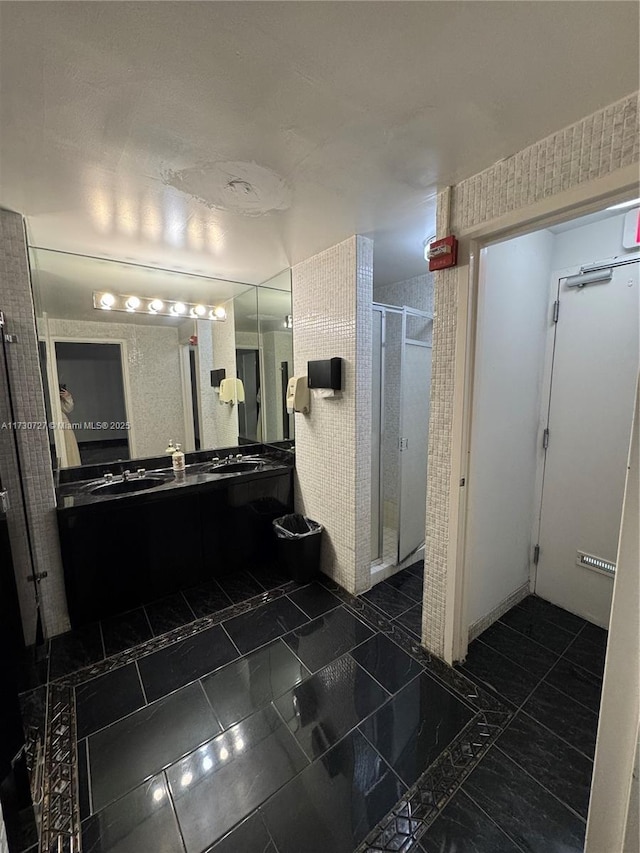 bathroom featuring vanity and an enclosed shower