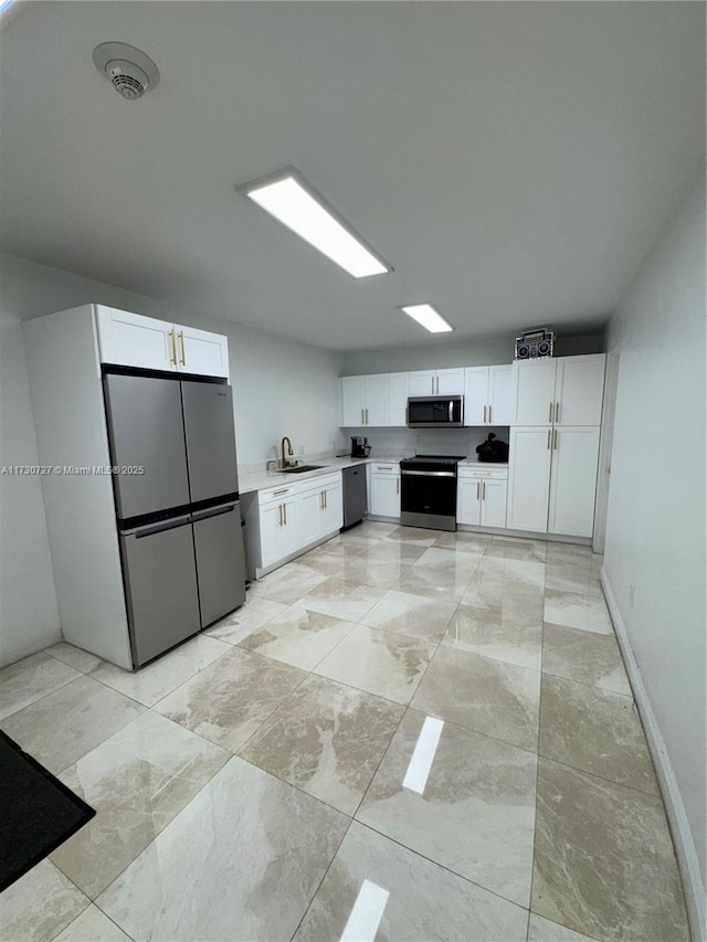 kitchen with white cabinetry, appliances with stainless steel finishes, and sink