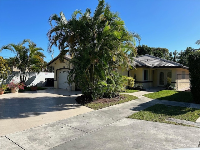 mediterranean / spanish-style home with a garage