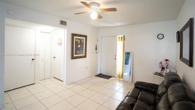 foyer with ceiling fan and light tile patterned floors