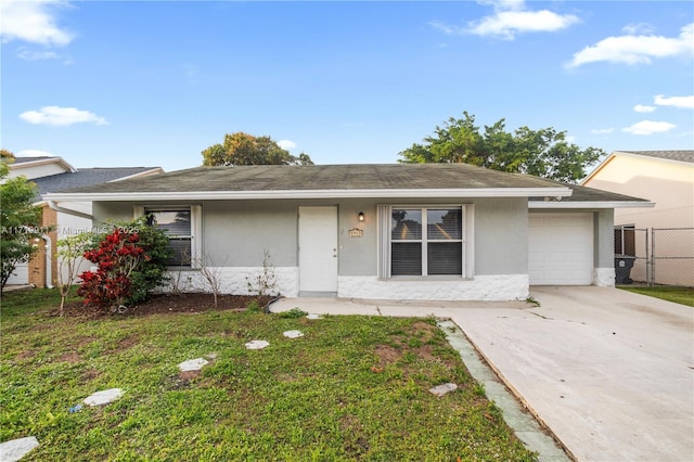 ranch-style home with a garage and a front yard