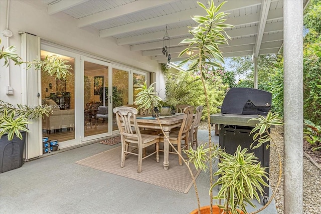 sunroom featuring beamed ceiling