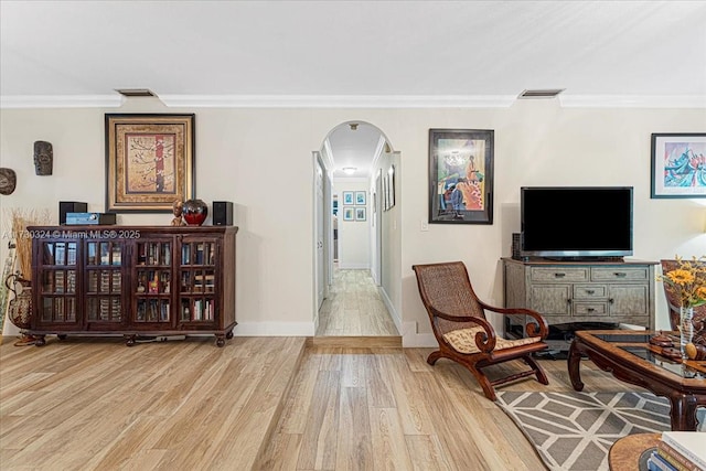 sitting room featuring light hardwood / wood-style flooring and ornamental molding