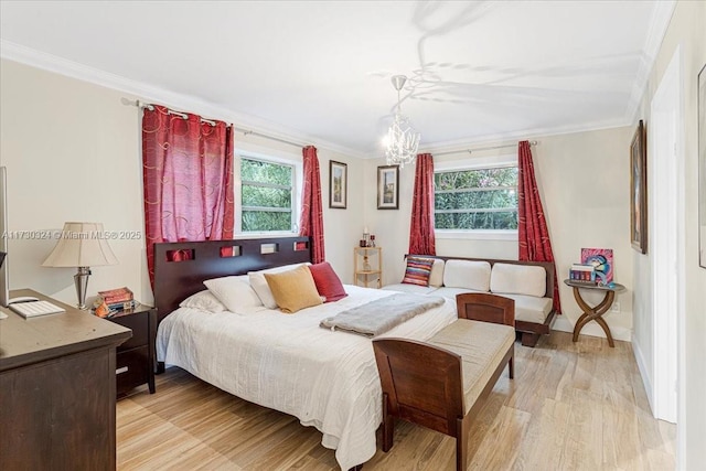 bedroom with light wood-type flooring, crown molding, and a notable chandelier