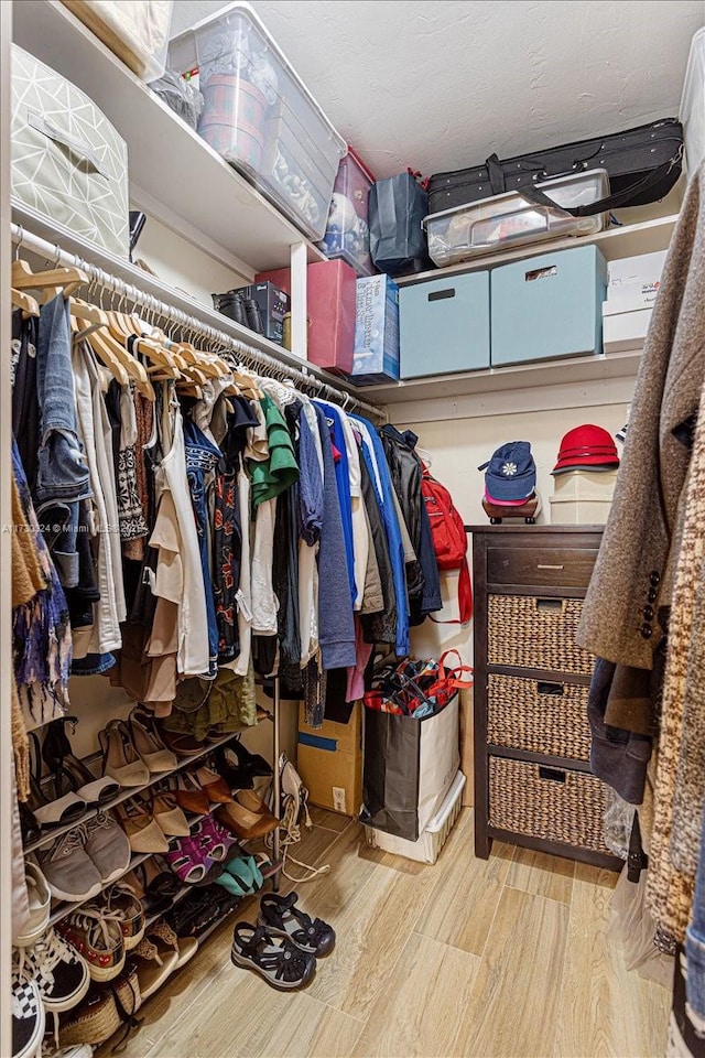 walk in closet with light wood-type flooring